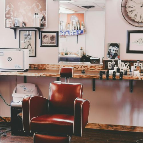 Interior design of modern light hairdressing studio with cozy leather chair and stylish decorative elements